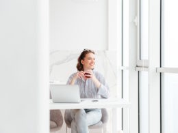 Woman sitting at white desk