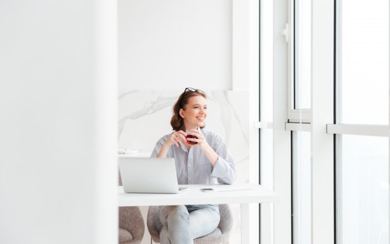 Woman sitting at white desk