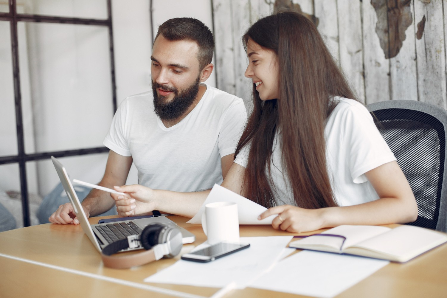 Two people working together on a laptop