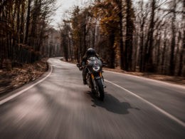 Biking a motorcycle in the forest.