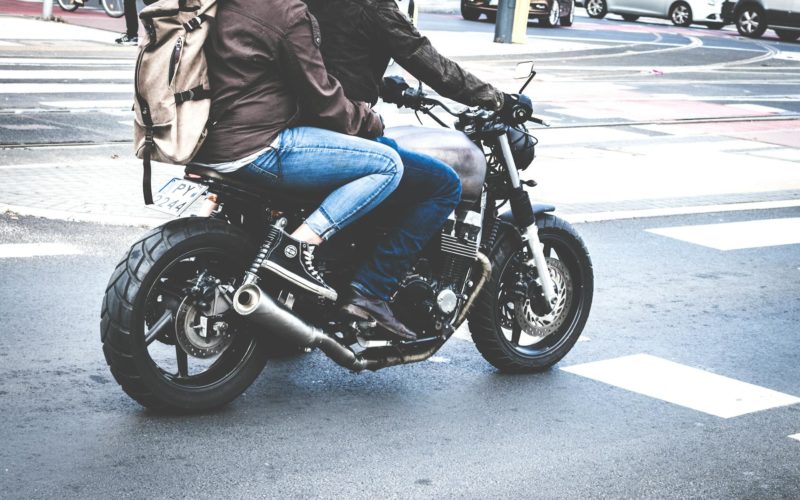 Two Person Riding Gray Cafe Racer