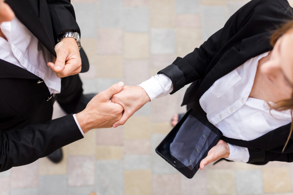 Business people shaking their hands