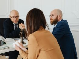 A Lawyer Talking to the Woman Wearing Brown Blazer