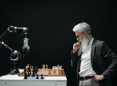 Elderly Man Thinking while Looking at a Chessboard