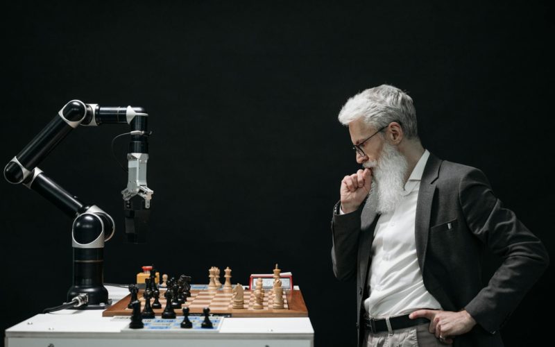 Elderly Man Thinking while Looking at a Chessboard