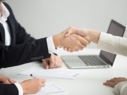 Hr handshaking successful candidate getting hired at new job
