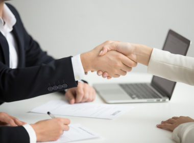 Hr handshaking successful candidate getting hired at new job