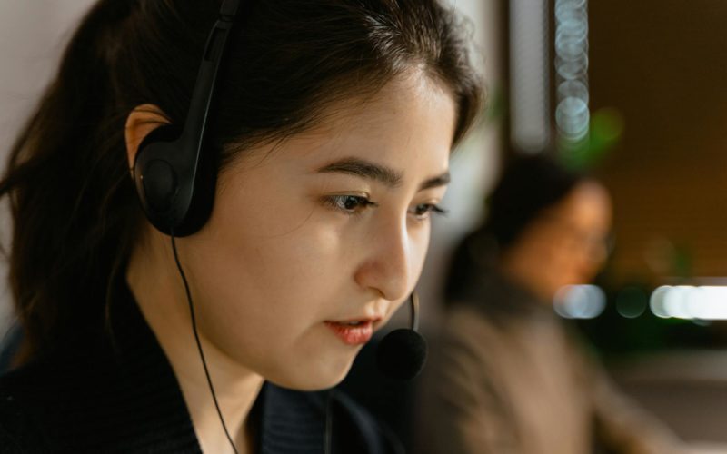 A Close-Up Shot of a Woman Wearing a Headset