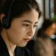 A Close-Up Shot of a Woman Wearing a Headset