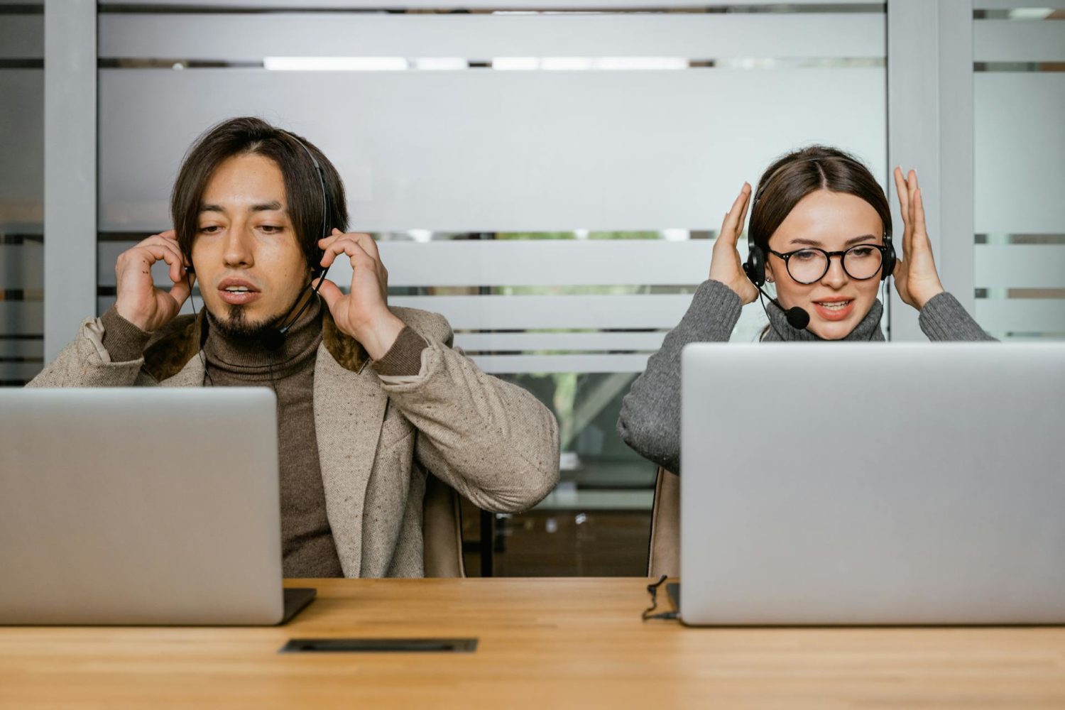 Photo of a Man and a Woman Putting on Their Headsets