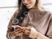 Smiling woman texting on her phone