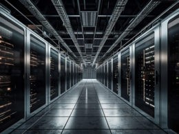 A long hallway with a row of servers in the center.