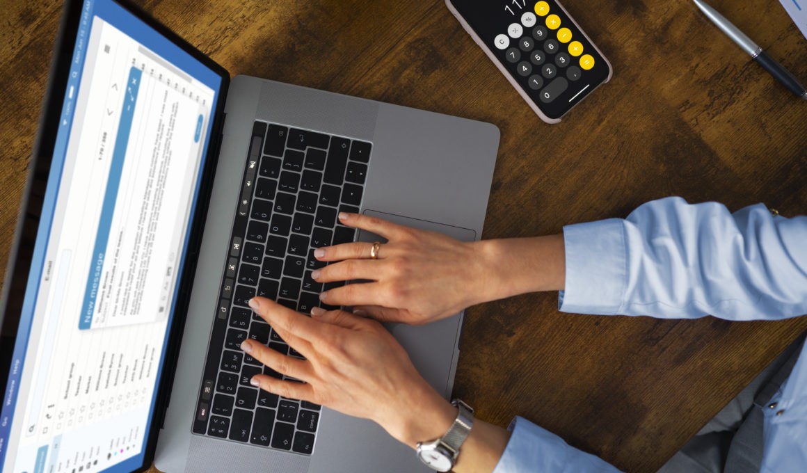Top view woman typing on laptop