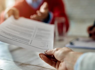 job applicant giving his resume during job interview in the office
