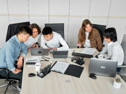 A Group of People Discussing in an Office