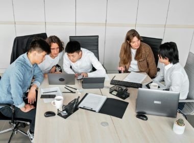 A Group of People Discussing in an Office