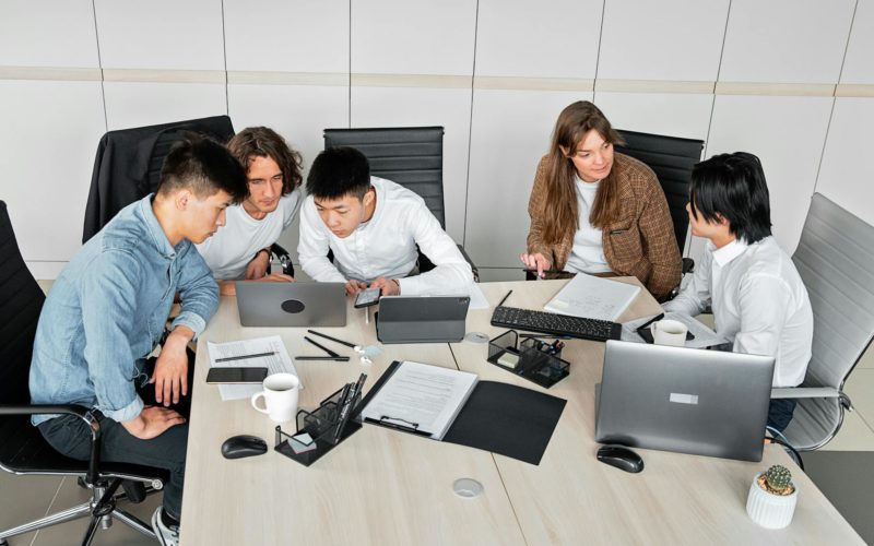 A Group of People Discussing in an Office