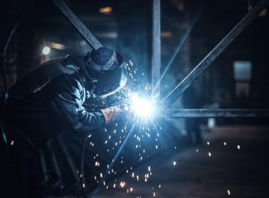 Welding work with metal construction at busy metal factory