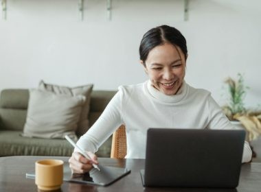 Woman working at home and making video call on laptop