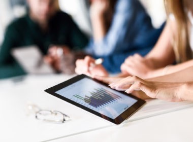 Group of young men and woman coworking with tablet computer