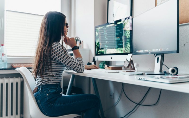 girl using desktop computer in room