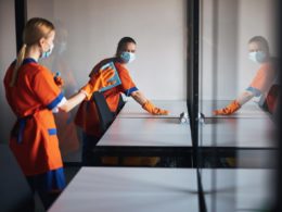 Two Workers Rubber Gloves Cleaning Surfaces