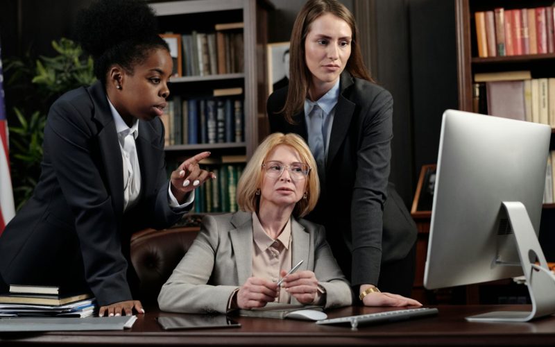Female Lawyers in an Office Looking at a Computer
