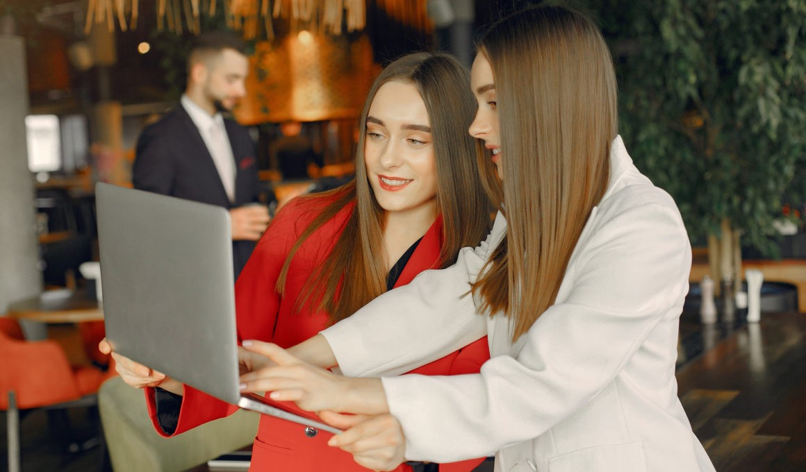 Two businesswomen working in a cafe