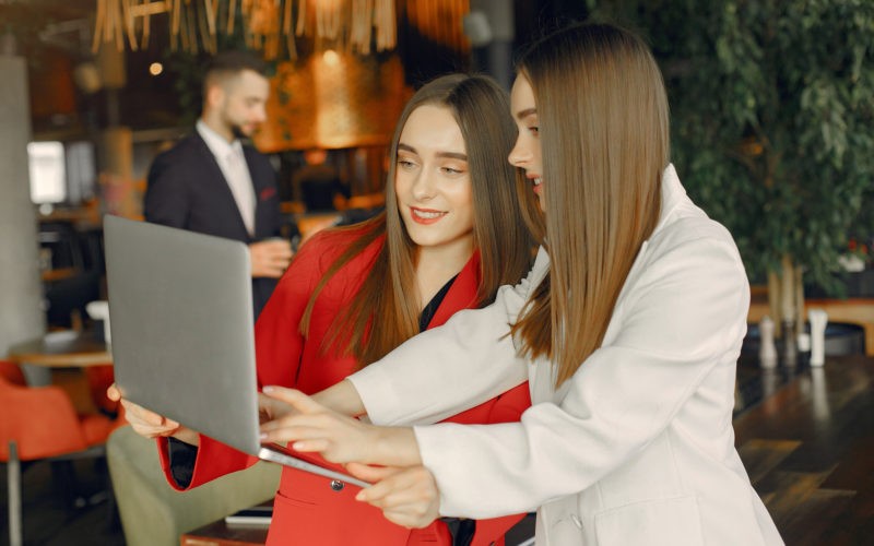 Two businesswomen working in a cafe