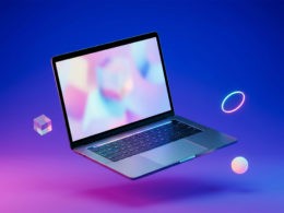 A modern laptop floating in mid-air against a vivid blue-and-magenta gradient, surrounded by geometric objects.