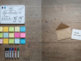 Overhead view of a desk split between structured internal team tools and a lone outreach letter representing the gap in external communication